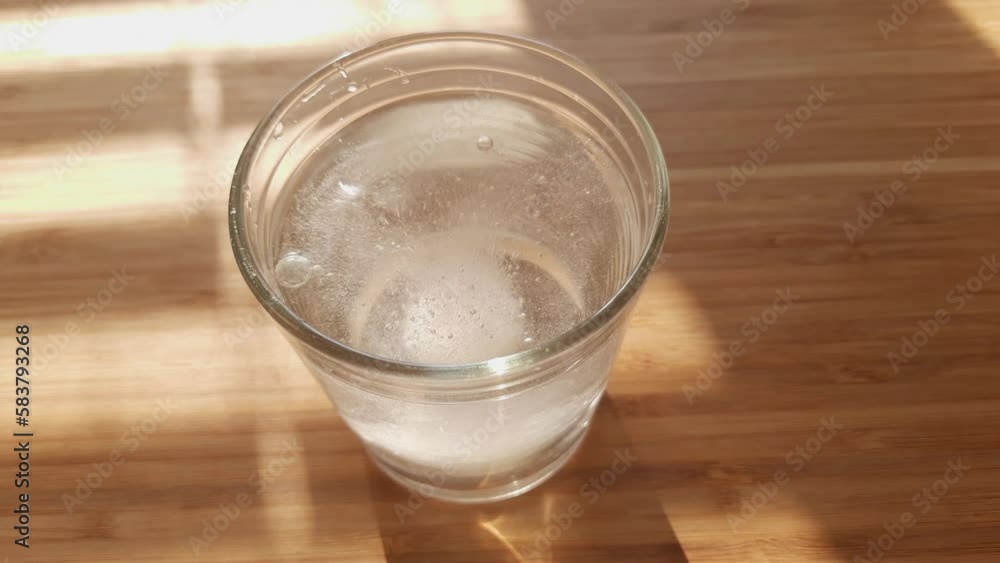 Dissolving start of effervescent tablet in the water glass Dissolving start of effervescent tablet in the water glass