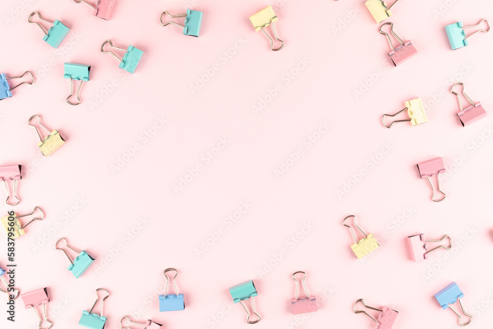 colorful binder clip on pink background colorful binder clip on pink background