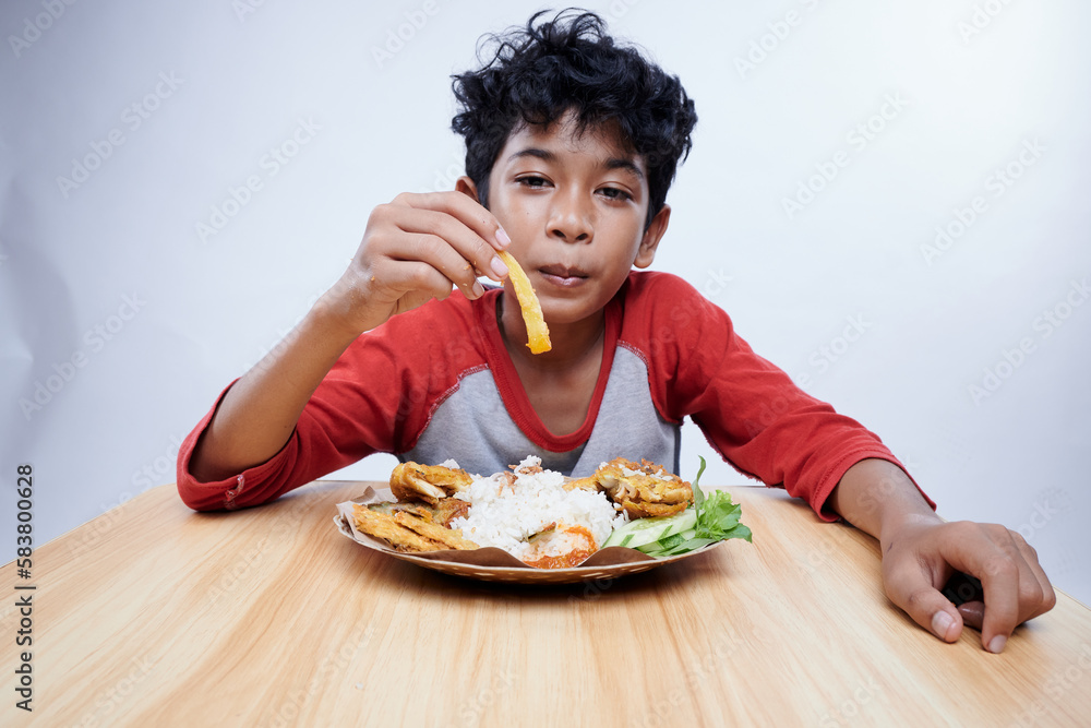 Child having Fried Chicken and rice for lunch Child having Fried Chicken and rice for lunch