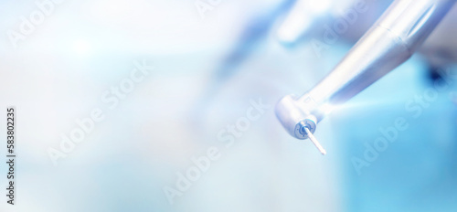 Closeup photo of dental handpieces and equipment on dental chair with blured background. photo