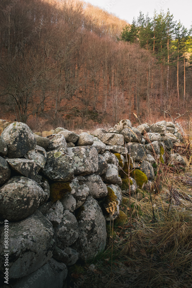 Beautiful morning scenery with a big stone wall in the foreground. Beautiful morning scenery with a big stone wall in the foreground.