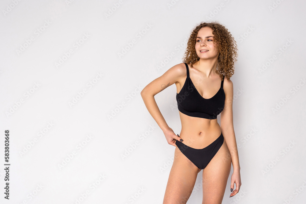 Fitness woman with a beautiful body in black lingerie isolated on white background Fitness woman with a beautiful body in black lingerie isolated on white background