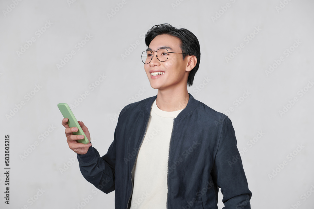 Smart casual asian man using smartphone in studio background Smart casual asian man using smartphone in studio background