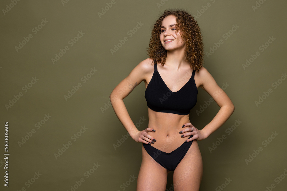Young sexy woman in black lingerie over khaki background Young sexy woman in black lingerie over khaki background