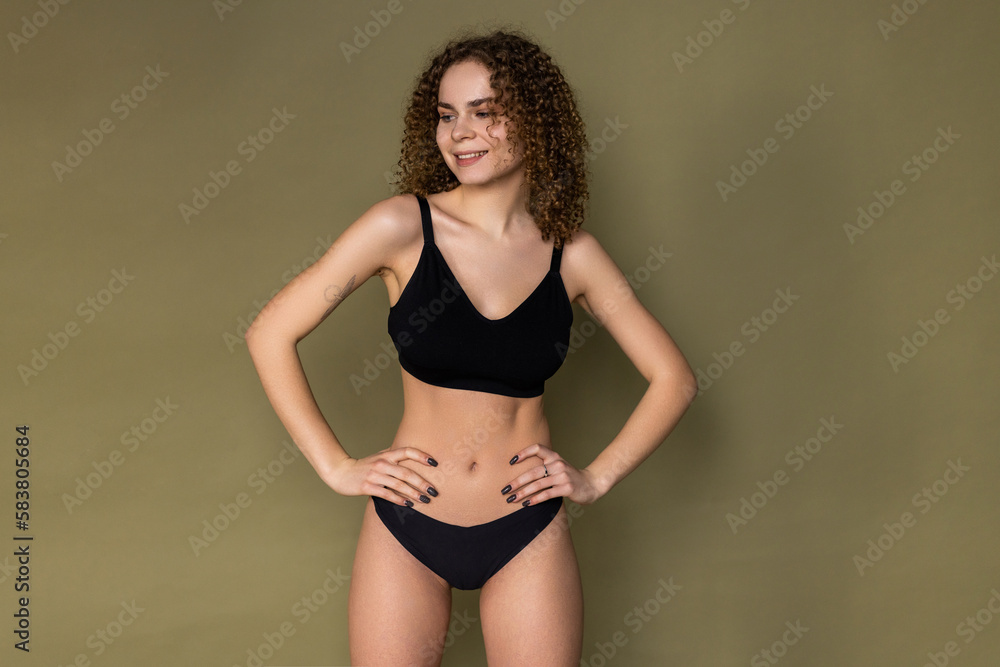 Young sexy woman in black lingerie over khaki background Young sexy woman in black lingerie over khaki background