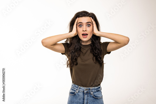 Amazed woman looking at camera on a white background