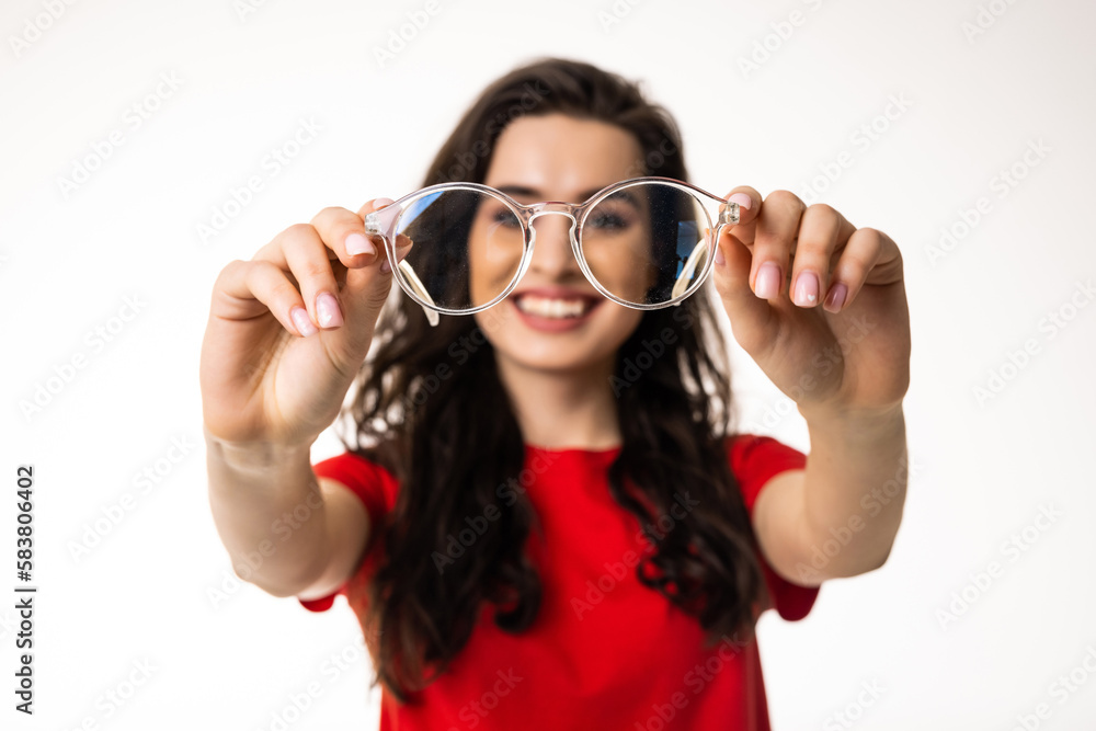 Smiling brunette woman in eyeglasses over white background Smiling brunette woman in eyeglasses over white background