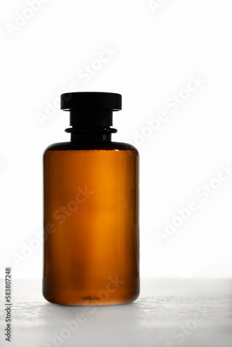 Abstract brown bottle at white background. Shampoo, body or lotion cosmetic concept
