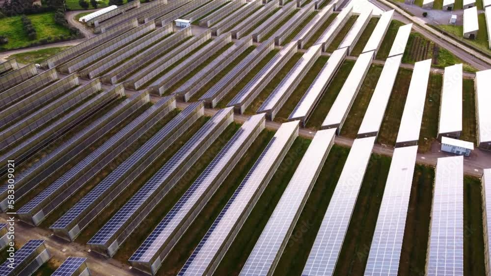 4K Aerial shot of solar panel array on top of greenhouse farm roofs. 4K Aerial shot of solar panel array on top of greenhouse farm roofs.