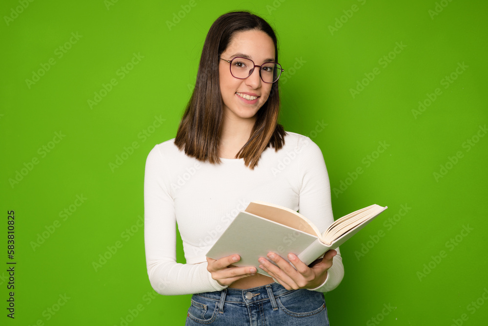 Photo of smiling shiny toothy clever lady reading book wear casual outfit isolated green color background Photo of smiling shiny toothy clever lady reading book wear casual outfit isolated green color background