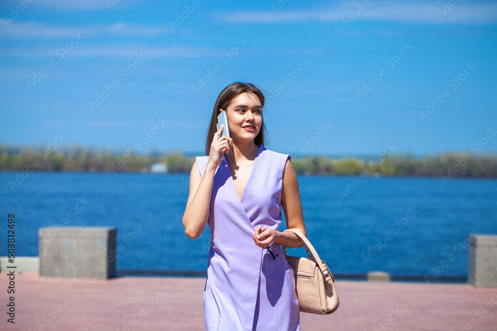 portrait of a young beautiful woman in a lilac dress