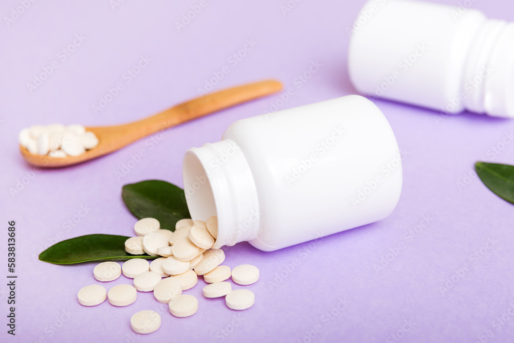 different drugs and health supplement pills poured from a medicine bottle health care and medical top view on colored background different drugs and health supplement pills poured from a medicine bottle health care and medical top view on colored background