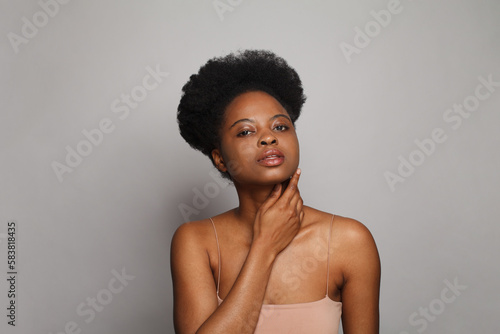 Healthy young woman with perfect dark clear skin, studio portrait