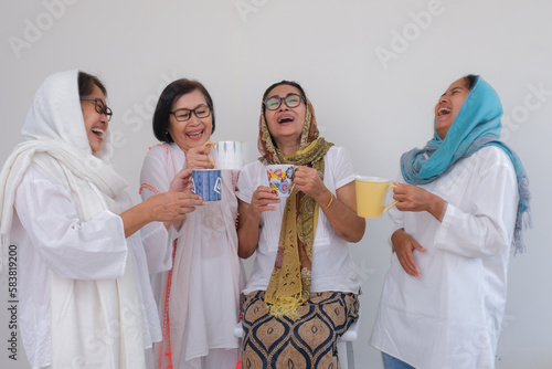 Group of moslem women standing together drinking to break their fast in Ramadan month photo