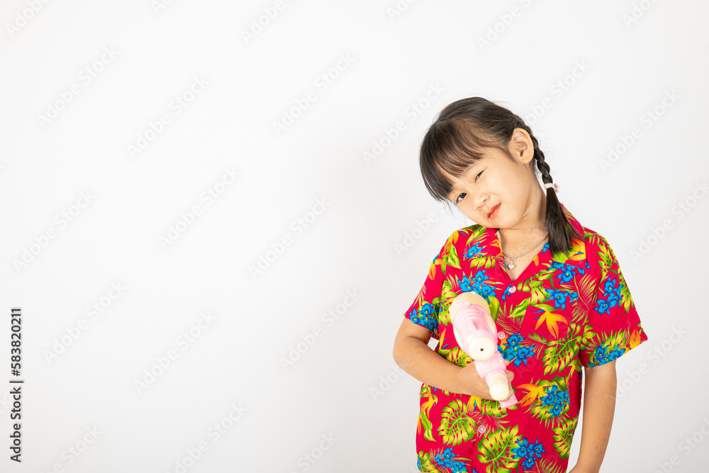 Happy Songkran Day, Asian kid girl with floral shirt hold water gun, Thai child funny hold toy water pistol and smile, isolated on white background, Thailand Songkran festival national culture concept Happy Songkran Day, Asian kid girl with floral shirt hold water gun, Thai child funny hold toy water pistol and smile, isolated on white background, Thailand Songkran festival national culture concept