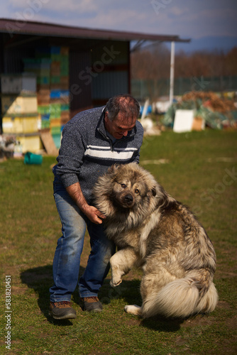 Man with a large fluffy guard dog