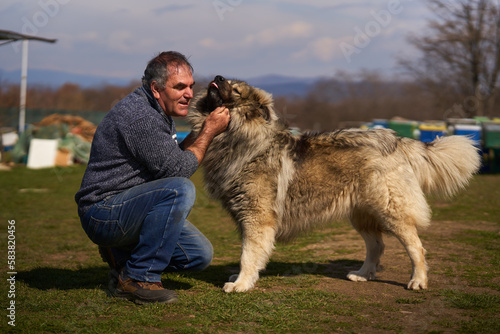 Man with a large fluffy guard dog