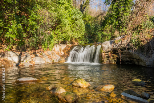 Water flowing over rocks in waterfall cascade in a forest