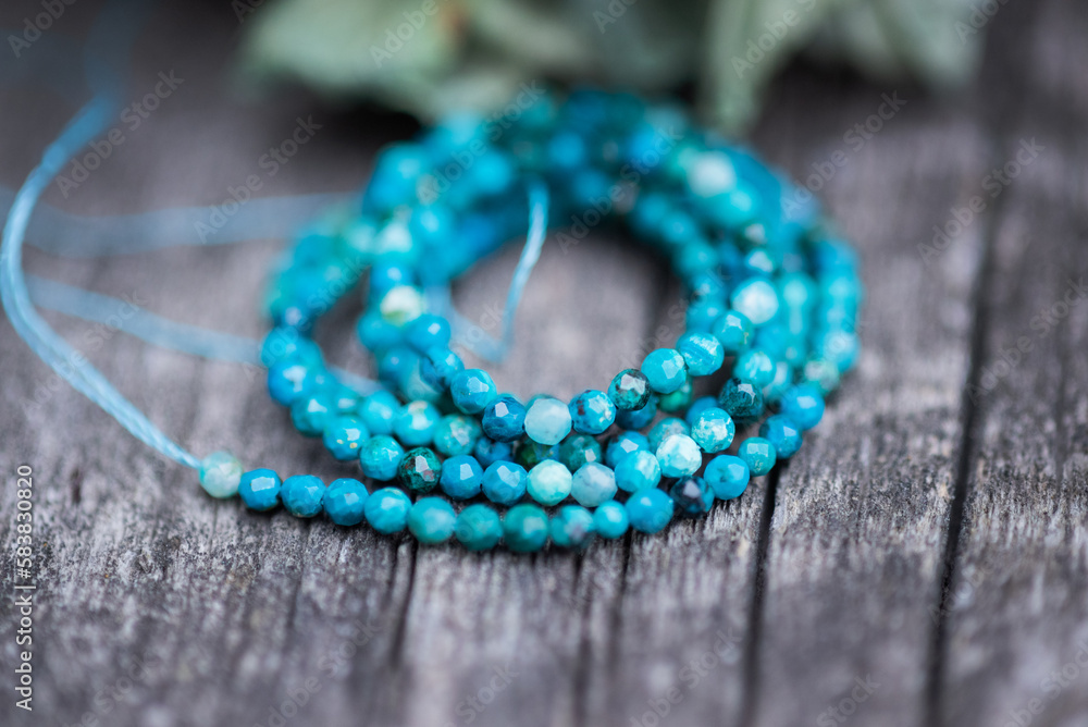 Φωτογραφία The photo with blue chrysocolla stones is made on the background of a wooden board and dried hydrangea