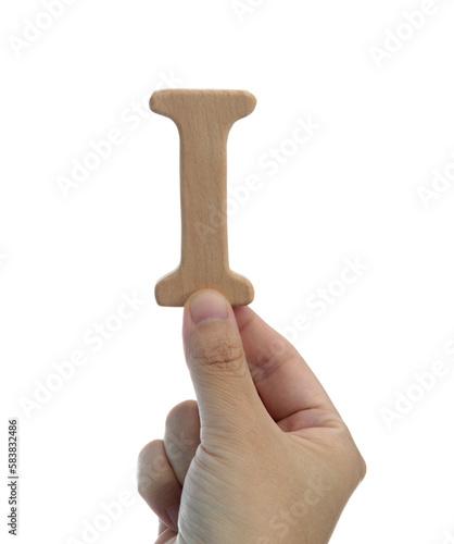 Hand holding wooden letter I