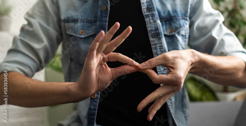 Tableau sur toile Sign language interpreter man translating a meeting to ASL, American Sign Language