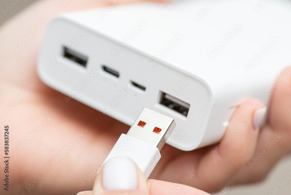 Inserting usb type a cable to the power bank. Charging electronic device using powerbank