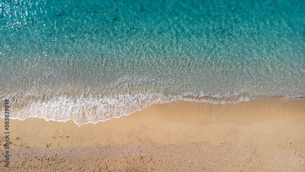 Aerial view of beautiful sandy beach and soft turquoise ocean wave. Tropical sea in summer season on Egremni beach on Lefkada island. Aerial view of beautiful sandy beach and soft turquoise ocean wave. Tropical sea in summer season on Egremni beach on Lefkada island.
