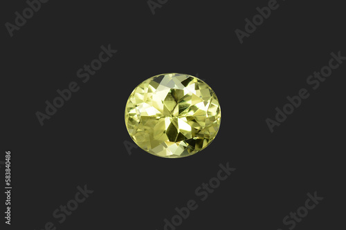 Natural bright lemon yellow color chrysoberyl oval shaped, faceted loose gemsotne. Isolated on black  background. Position in center. Setting for jewelry making. Unheated, untreated, earth mined gem.