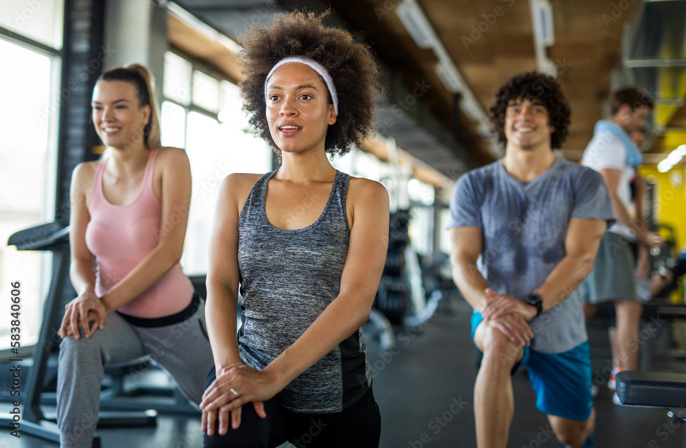 Fototapeta premium Group of young people, friends smiling and enjoy sport in gym. People exercise, work out concept.