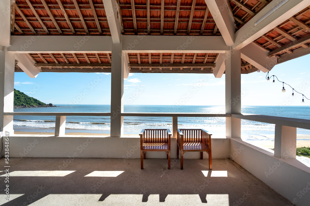 Two wooden chairs in the gazebo overlooking the sea. The concept of loyalty, couple friendship