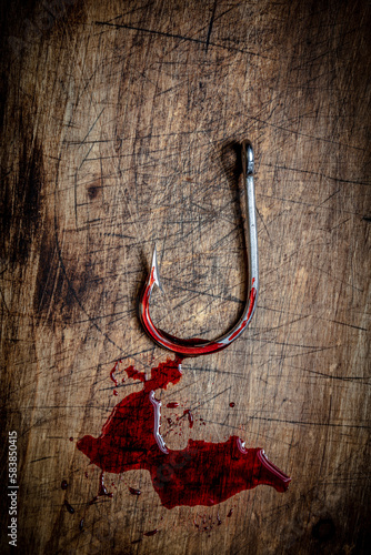bloody steel hook on wooden bottom © tiero