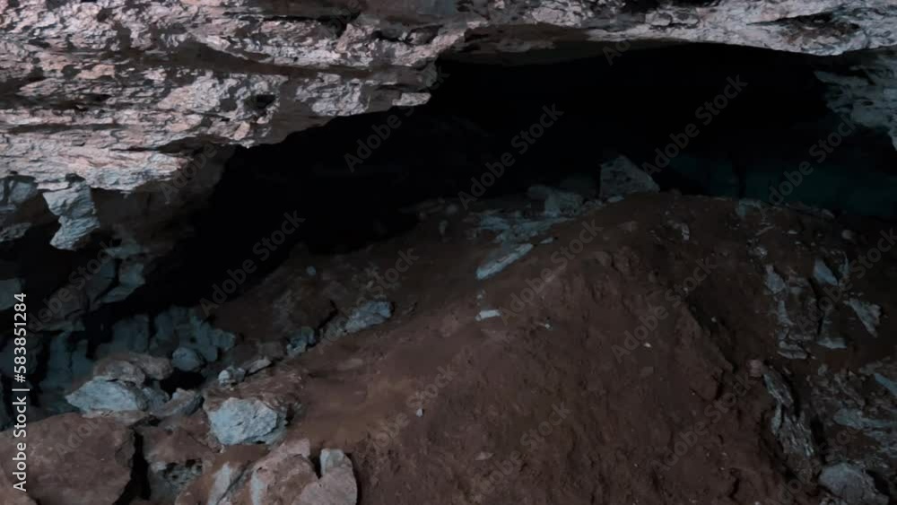 Excursion to the dark ice cave in winter. Underground large stone cave ...