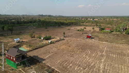 Drone footage above a typical landscape in countryside, with farm and fields in Stung Treng province, Cambodia  photo