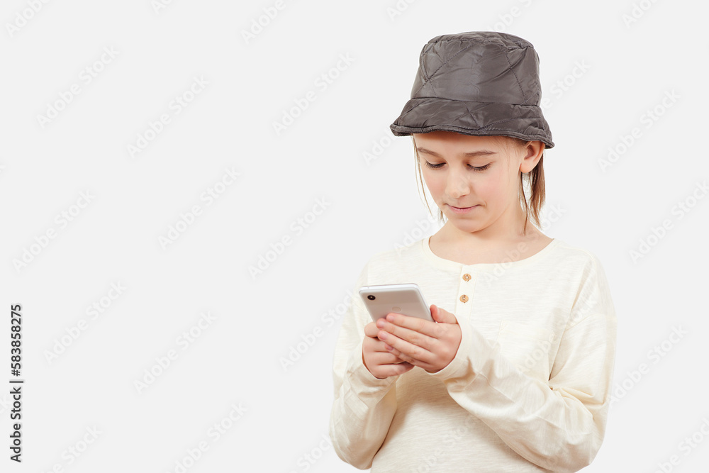 Pensive young boy with a serious face thinking about a question. Smart kid holding a mobile phone. Pensive young boy with a serious face thinking about a question. Smart kid holding a mobile phone.
