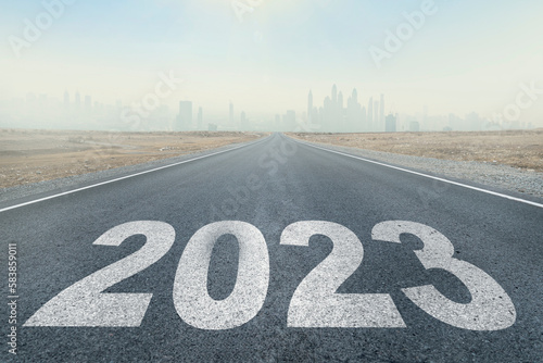 2023 written on highway road in middle of empty asphalt road and beautiful blue sky. Concept for vision new year 2023. future vision 2023