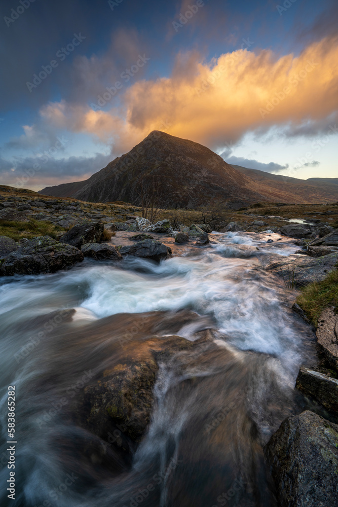 View of Tryfan with flowing river in Snowdonia National Park, Ogwen, Conwy, Wales