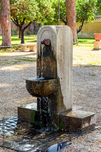 Free public fountain with drinkable water on Aventine hill, Rome, Italy