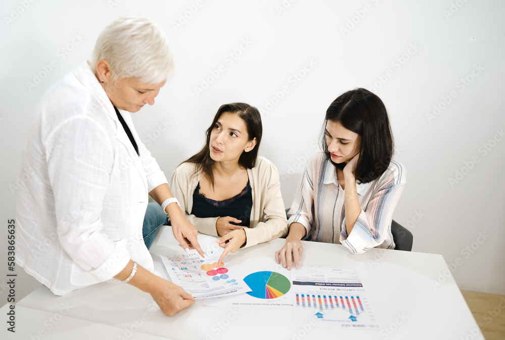 Aged businesswoman meeting with colleague teamwork women talking, planning business strategy for collaboration. Professional female mature manager working in office discussing startup project document Aged businesswoman meeting with colleague teamwork women talking, planning business strategy for collaboration. Professional female mature manager working in office discussing startup project document