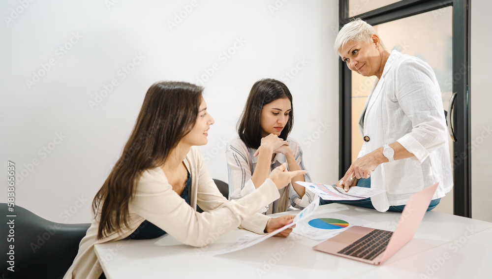 Aged businesswoman meeting with colleague teamwork women talking, planning business strategy for collaboration. Professional female mature manager working in office discussing startup project document Aged businesswoman meeting with colleague teamwork women talking, planning business strategy for collaboration. Professional female mature manager working in office discussing startup project document