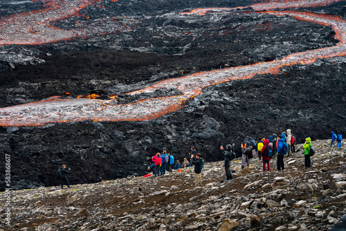 Tourists watching flowing lava at Fagradalsfjall volcano, Reykjanes Peninsula, Iceland, Polar Regions photo