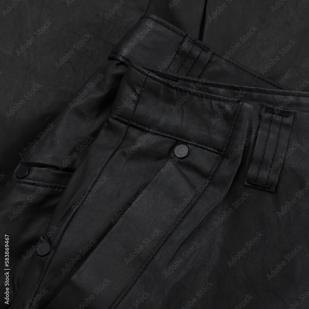 Detail of a black waxed trouser belt with loop and pocket Detail of a black waxed trouser belt with loop and pocket