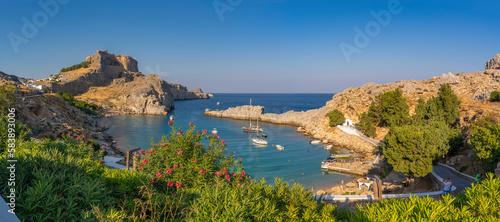View of sailboats in the bay, Lindos and Lindos Acropolis from elevated position, Lindos, Rhodes, Dodecanese Island Group, Greek Islands photo