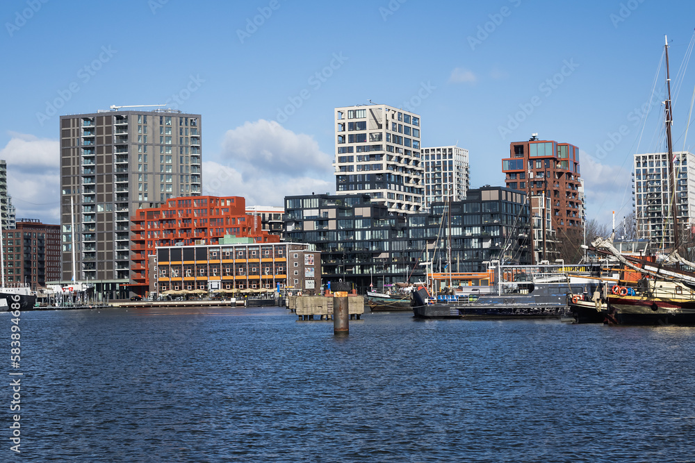 Panoramic view from the IJ river to NDSM neighborhood (Amsterdam-Noord borough), located on the former terrain NDSM-wharf, along the IJ river. AMSTERDAM, The NETHERLANDS.