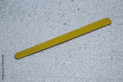 yellow nail file with white background