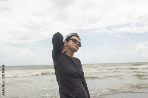 Woman in sunglasses on the beach