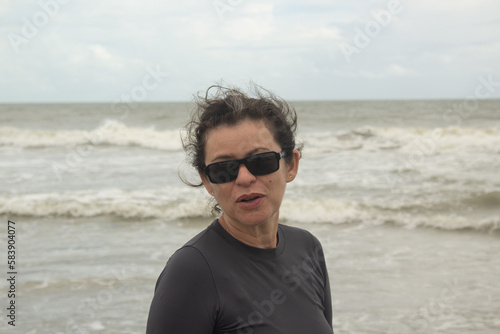 Woman in sunglasses on the beach