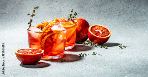 refreshing alcoholic cocktail with Sicilian red oranges, Aperitif on a light background. Long banner format. top view