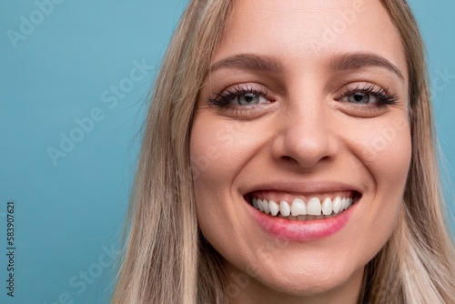portrait of a woman with a snow-white Hollywood smile and on a blue background