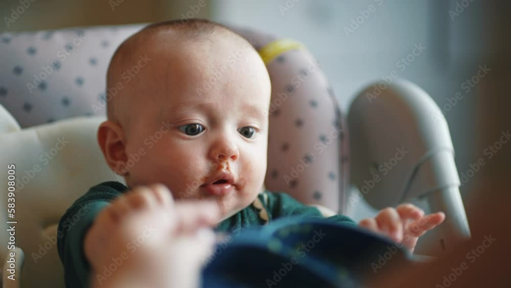 baby newborn eats. dirty mess baby boy eating vegetables. baby son eats on a feeding chair dirty face. naughty dirty babe indoors indulges while feeding. happy kid dream family weaning concept baby newborn eats. dirty mess baby boy eating vegetables. baby son eats on a feeding chair dirty face. naughty dirty babe indoors indulges while feeding. happy kid dream family weaning concept