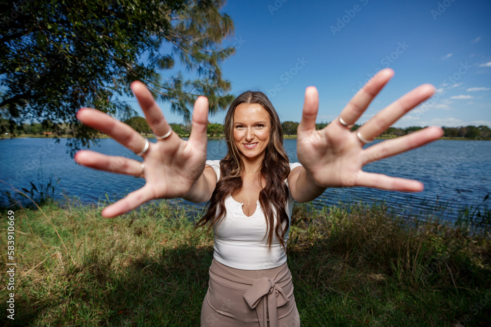 Abstract photo of a woman smiling and reaching hand towards camera Abstract photo of a woman smiling and reaching hand towards camera